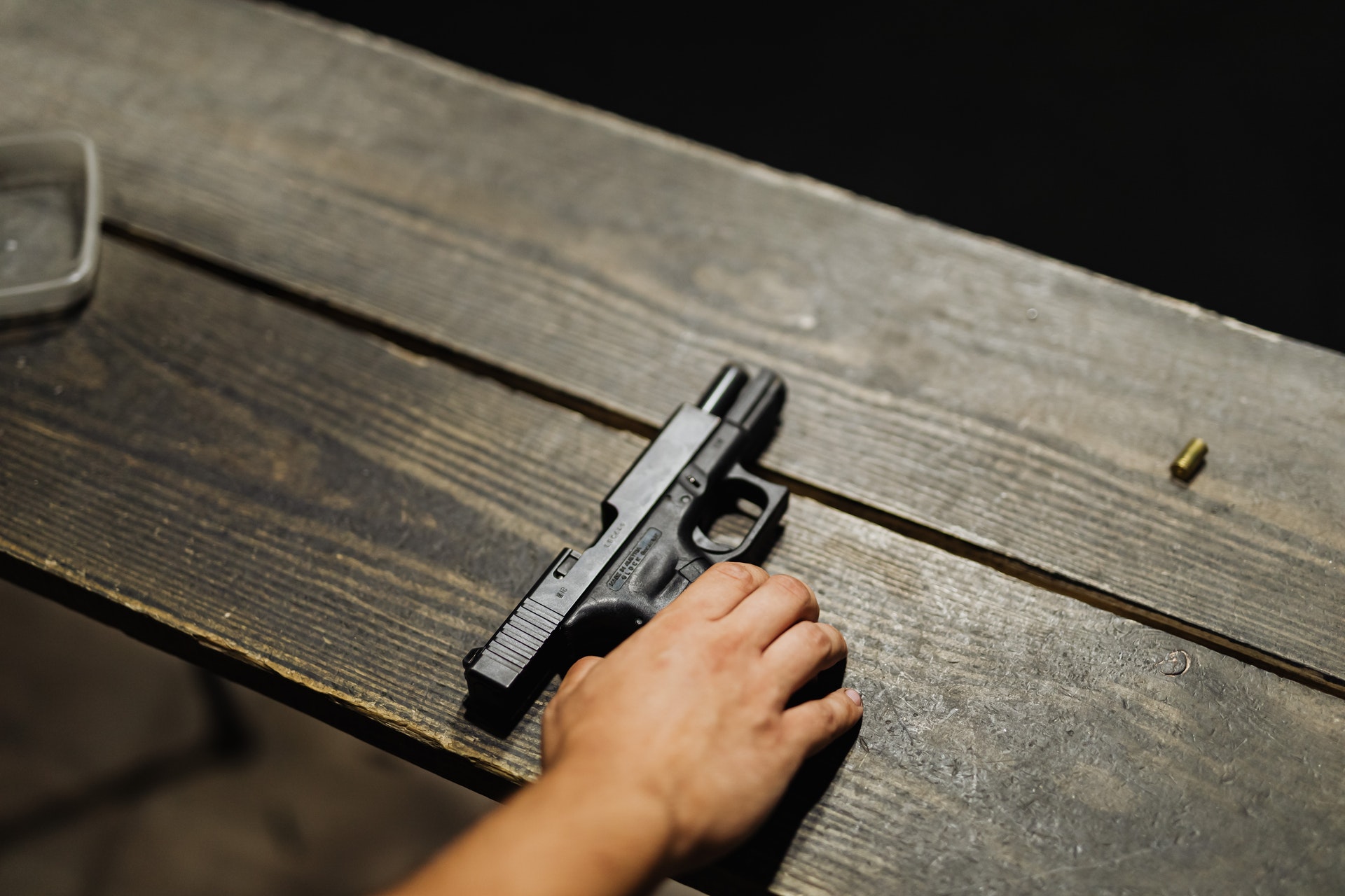 hand-of-a-person-holding-black-semi-automatic-pistol